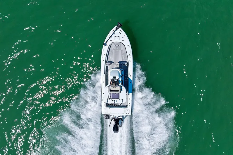 Slide: The Image of Aerial view of 2020 Barker Boatworks 26 Open speeding on green water. - 29