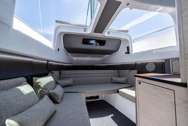 Slide: The Image of 2025 Axopar 45 Cross Top interior with modern seating and sleek design. - 10