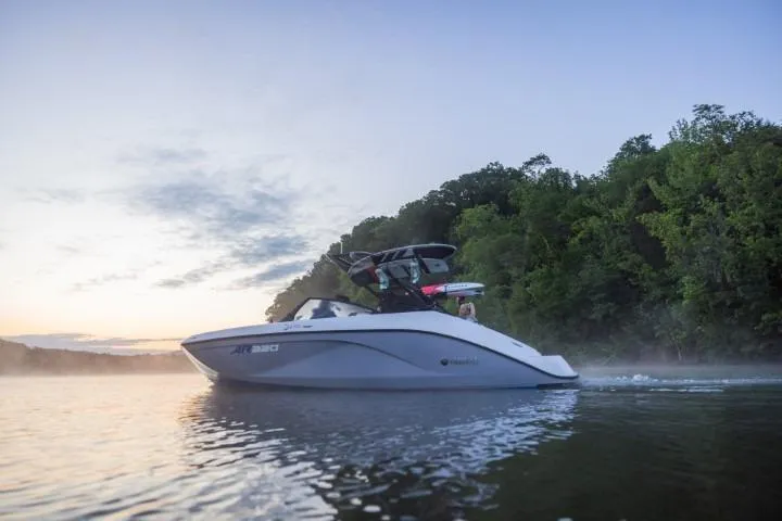 Slide: The Image of 2026 Yamaha Boats AR220 cruising on a serene lake at sunset. - 12