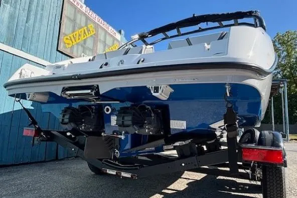 Slide: The Image of 2026 Yamaha Boats AR220 on trailer, rear view, blue and white design. - 4