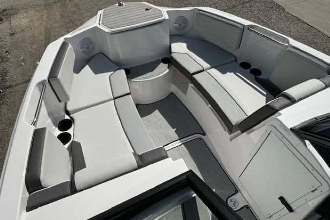 Slide: The Image of 2026 Yamaha Boats AR220 interior with spacious seating and cup holders. - 6