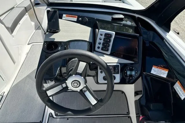 Slide: The Image of 2026 Yamaha Boats AR220 dashboard with steering wheel, control panel, and modern navigation system. - 8