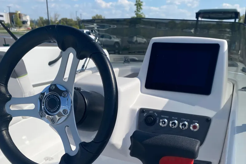Slide: The Image of 2024 Tahoe T18 boat dashboard with steering wheel and control panel. - 4