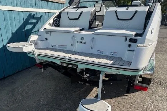 Slide: The Image of 2026 Yamaha Boats 222S with sleek design and modern seating, docked outdoors. - 20