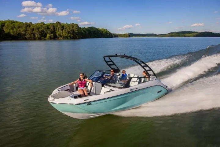 Slide: The Image of 2026 Yamaha Boats 222S cruising on a scenic lake with passengers enjoying the ride. - 21