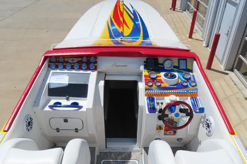 Slide: The Image of 2003 Cigarette 38 Top Gun boat cockpit with colorful dashboard and steering wheel. - 15