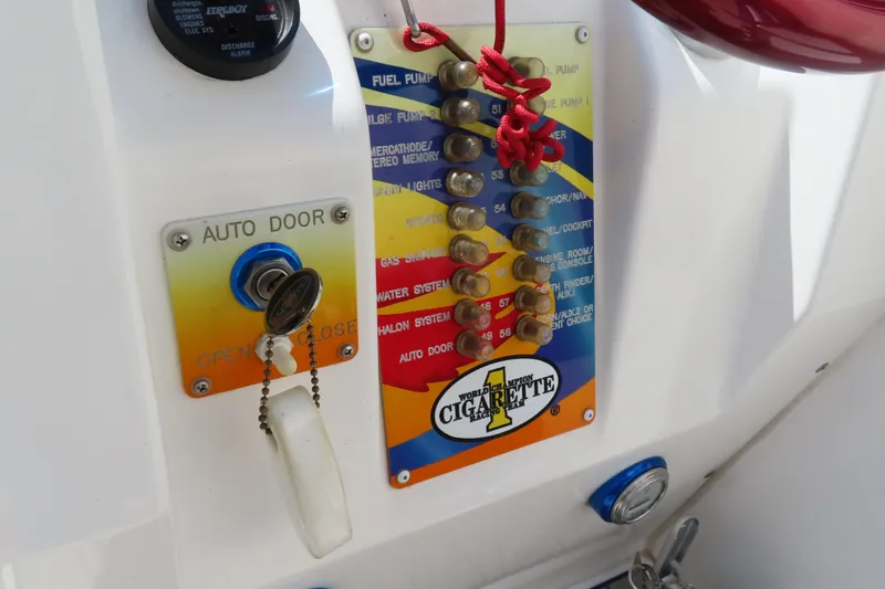 Slide: The Image of Control panel of a 2003 Cigarette 38 Top Gun boat with key and switches. - 19