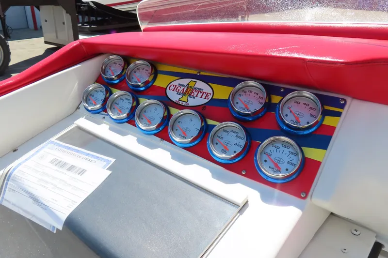 Slide: The Image of Dashboard of 2003 Cigarette 38 Top Gun boat with gauges and red upholstery. - 21