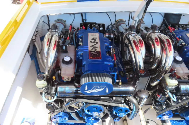 Slide: The Image of 2003 Cigarette 38 Top Gun engine with chrome headers and blue accents. - 26