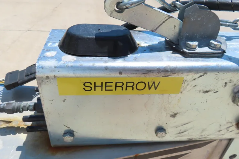 Slide: The Image of Close-up of a metal component labeled "SHERROW" on a 2003 Cigarette 38 Top Gun. - 5