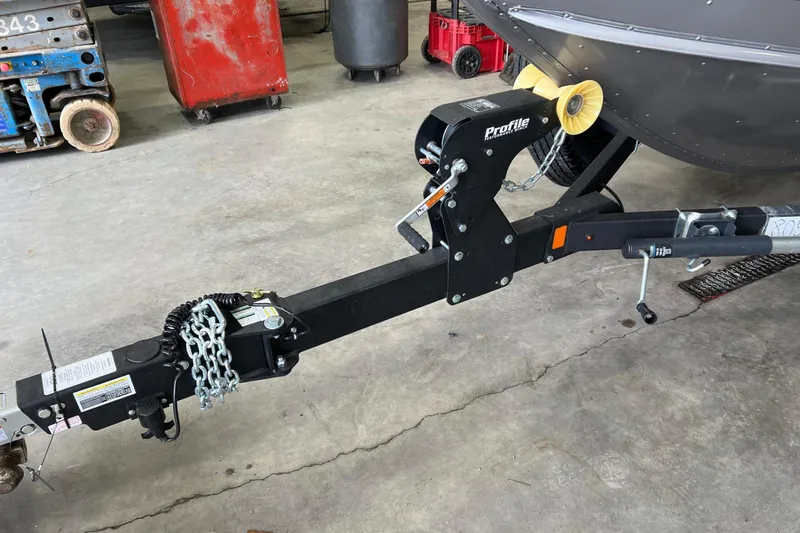 Slide: The Image of Trailer hitch of 2026 Lund 1875 Fisherman boat in a garage setting. - 11