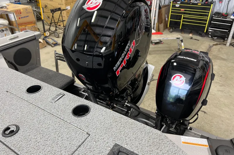 Slide: The Image of 2026 Lund 1875 Fisherman boat with Mercury Pro XS outboard motors in a workshop. - 12