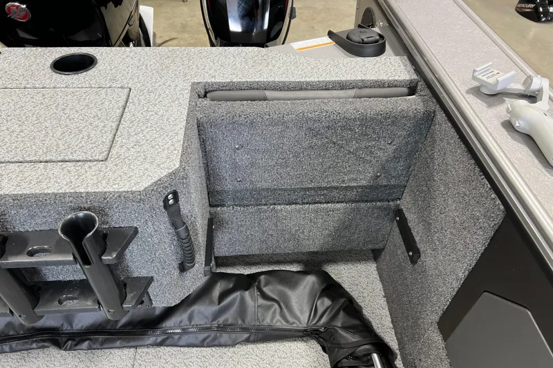 Slide: The Image of 2026 Lund 1875 Fisherman boat interior with storage compartments and rod holders. - 15