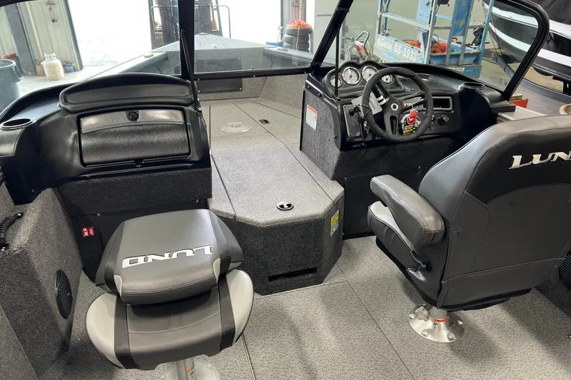 Slide: The Image of 2026 Lund 1875 Fisherman boat interior with steering console and seating. - 18