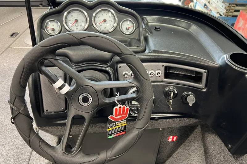 Slide: The Image of 2026 Lund 1875 Fisherman dashboard with steering wheel and gauges. - 21