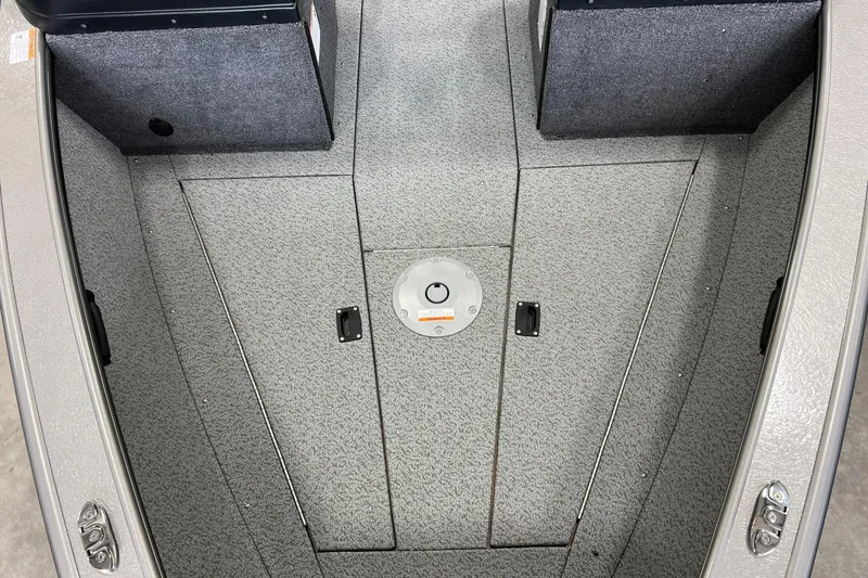 Slide: The Image of 2026 Lund 1875 Fisherman boat interior, featuring a textured deck and storage compartments. - 27