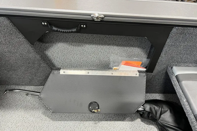 Slide: The Image of Interior of 2026 Lund 1875 Fisherman boat showing storage compartment and handle. - 29