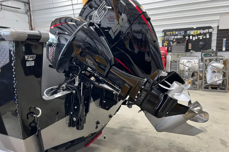 Slide: The Image of 2026 Lund 1875 Fisherman boat with powerful outboard motor in a workshop setting. - 4