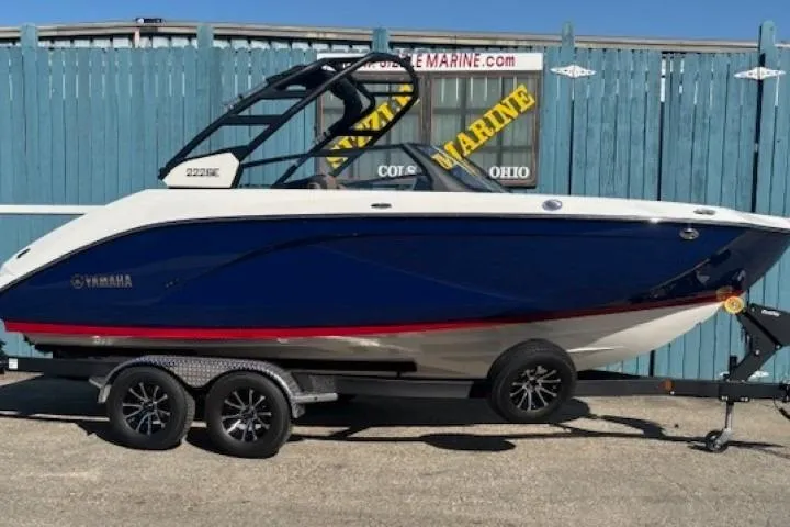 The Image of 2026 Yamaha Boats 222SE on trailer, blue and white design, parked outdoors. - 0