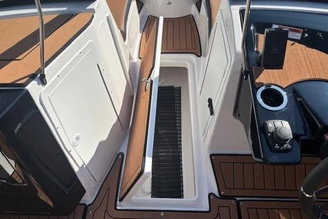 Slide: The Image of 2026 Yamaha Boats 222SE interior with open storage compartment and modern controls. - 12