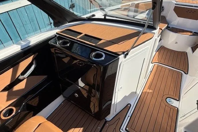 Slide: The Image of 2026 Yamaha Boats 222SE interior with sleek design and wood accents. - 13