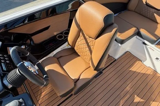Slide: The Image of 2026 Yamaha Boats 222SE interior with tan leather seats and wood-style flooring. - 18