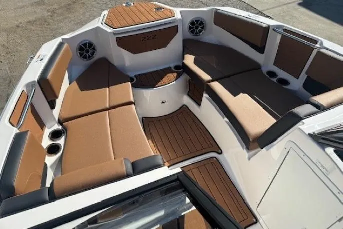 Slide: The Image of 2026 Yamaha Boats 222SE interior with brown seating and wood accents. - 7