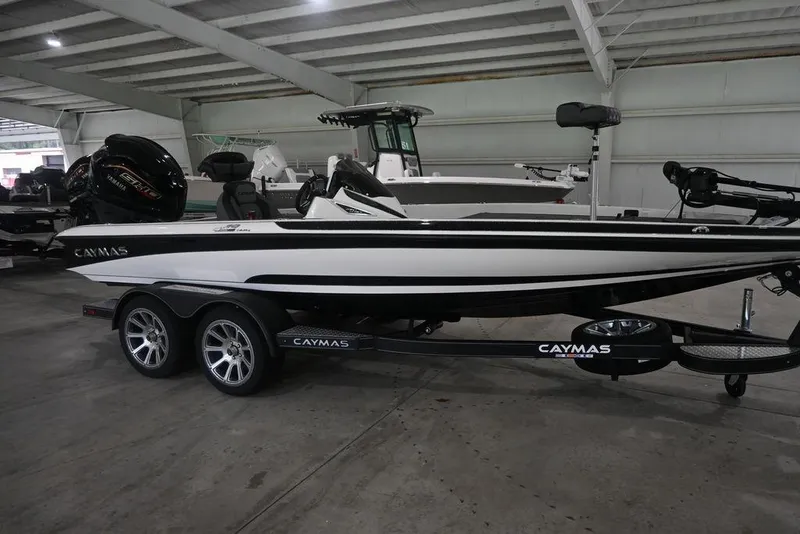 The Image of 2026 Caymas CX19 PRO boat in showroom, side view with trailer. - 1
