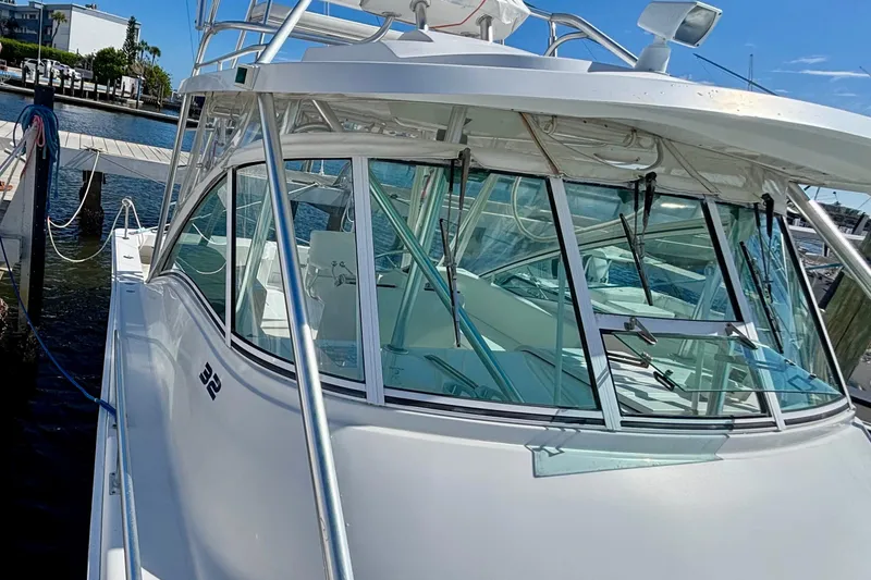 Slide: The Image of 2002 Luhrs 32 Open boat docked, showcasing sleek design and spacious cabin. - 10