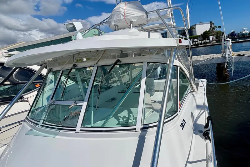 Slide: The Image of 2002 Luhrs 32 Open boat docked at marina under blue sky. - 11