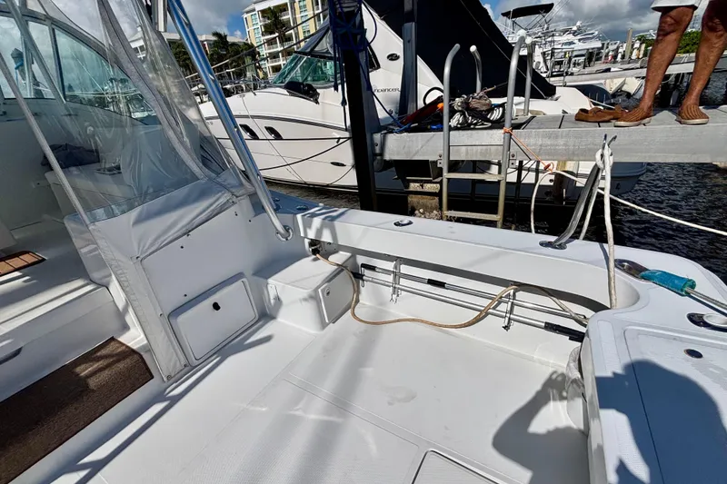 Slide: The Image of 2002 Luhrs 32 Open boat interior at marina, featuring clean deck and docked yachts. - 15