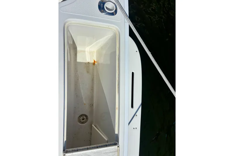 Slide: The Image of Open storage compartment on 2002 Luhrs 32 Open boat, showing interior details. - 18