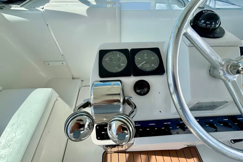 Slide: The Image of Control panel of 2002 Luhrs 32 Open boat with gauges and steering wheel. - 21