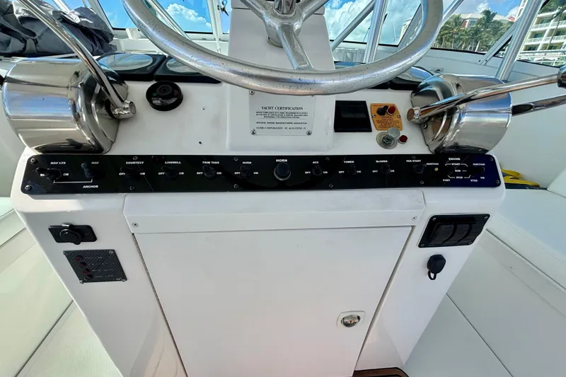 Slide: The Image of Control panel of a 2002 Luhrs 32 Open boat with steering wheel and switches. - 22