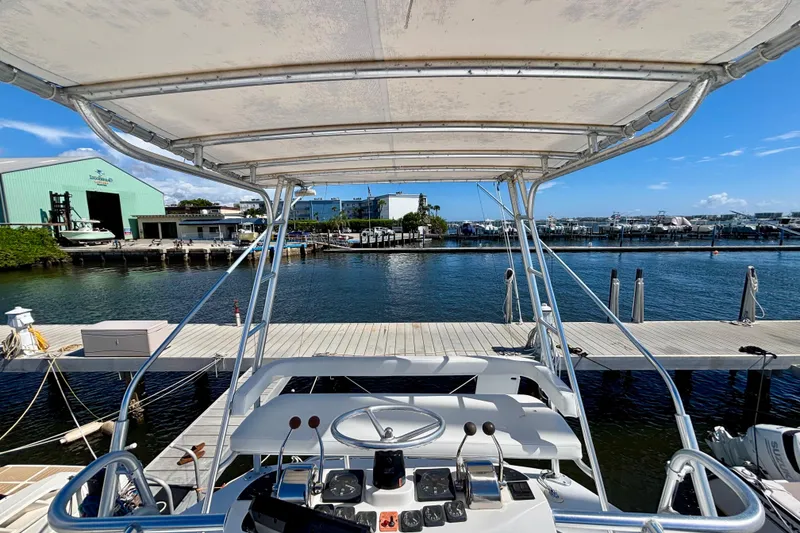 Slide: The Image of 2002 Luhrs 32 Open boat docked at a marina with clear blue skies. - 29