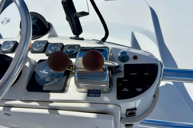 Slide: The Image of Control panel of a 2002 Luhrs 32 Open boat with throttle and gauges. - 32