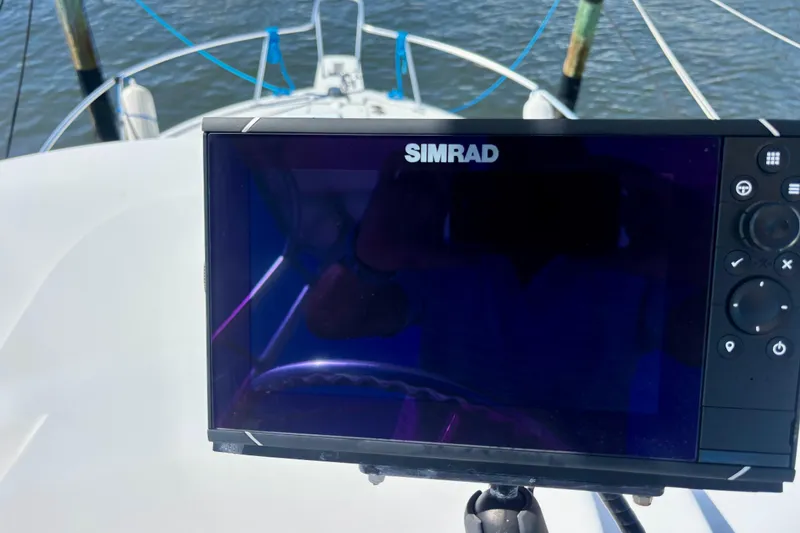 Slide: The Image of Simrad navigation system on 2002 Luhrs 32 Open boat, with water in the background. - 33