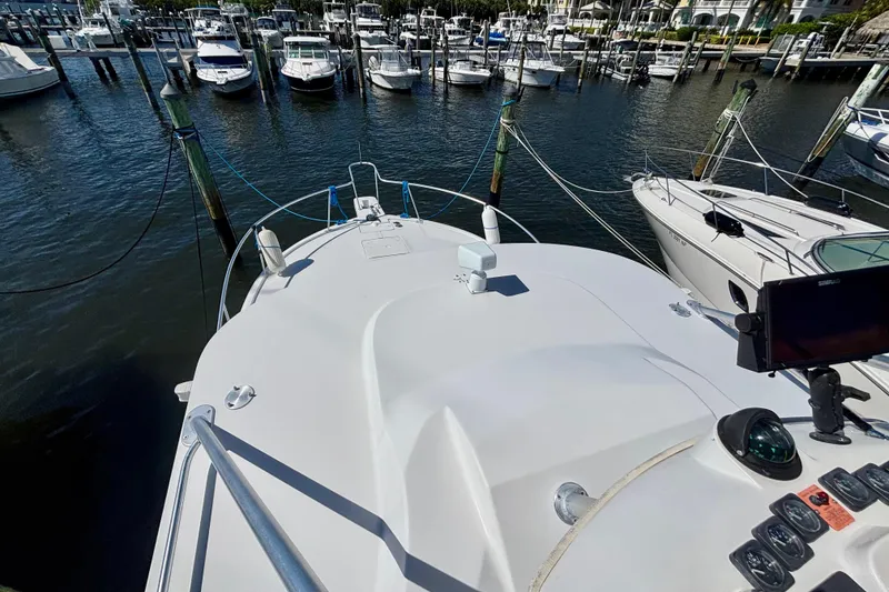 Slide: The Image of 2002 Luhrs 32 Open boat docked in a marina, surrounded by other vessels. - 34