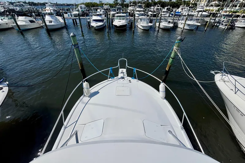 Slide: The Image of Bow view of 2002 Luhrs 32 Open yacht docked at marina with surrounding boats. - 35