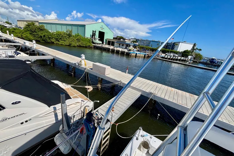 Slide: The Image of Marina view with boats docked, featuring a 2002 Luhrs 32 Open model. - 36