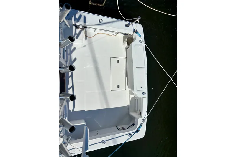 Slide: The Image of 2002 Luhrs 32 Open boat deck with fishing rod holders and storage compartments. - 38