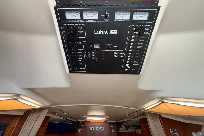 Slide: The Image of Control panel of a 2002 Luhrs 32 Open boat, featuring AC and DC systems. - 39