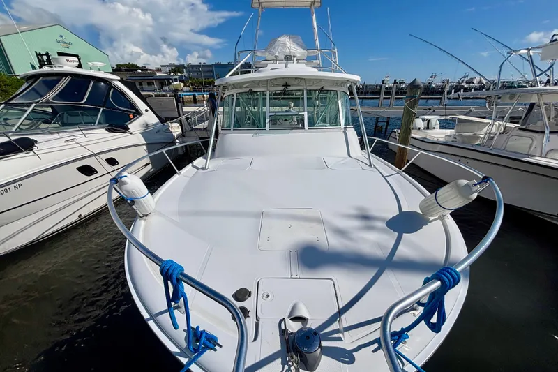 Slide: The Image of 2002 Luhrs 32 Open boat docked at marina, surrounded by other vessels. - 4
