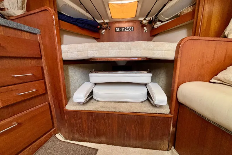 Slide: The Image of 2002 Luhrs 32 Open cabin interior with wooden cabinetry and storage space. - 43
