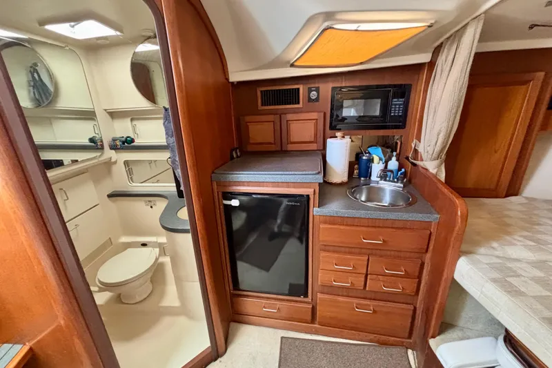Slide: The Image of 2002 Luhrs 32 Open yacht interior with kitchenette and bathroom. - 45