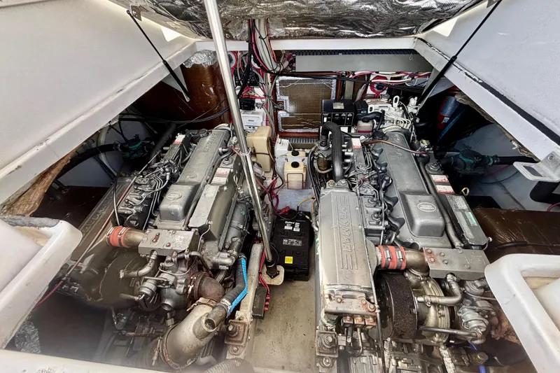 Slide: The Image of Engine compartment of a 2002 Luhrs 32 Open boat, showcasing dual engines and wiring. - 48