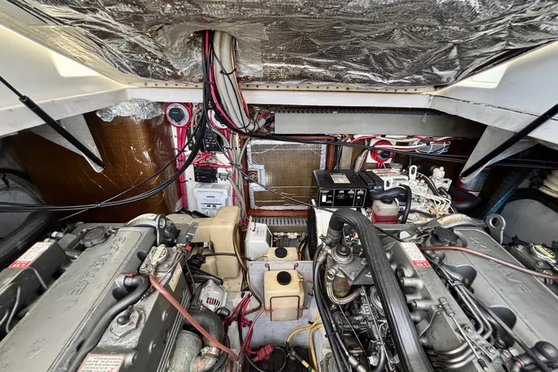 Slide: The Image of Engine room of 2002 Luhrs 32 Open boat, showcasing mechanical components and wiring. - 52
