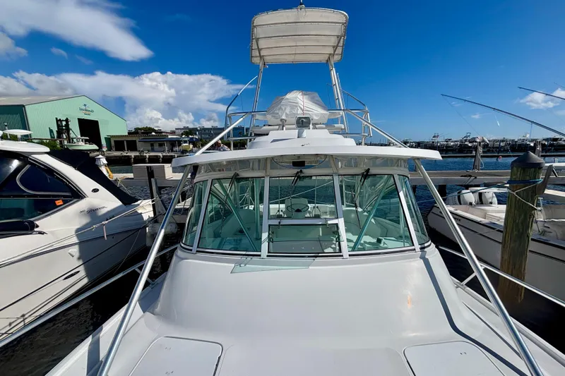 Slide: The Image of 2002 Luhrs 32 Open boat docked at marina under clear blue sky. - 9