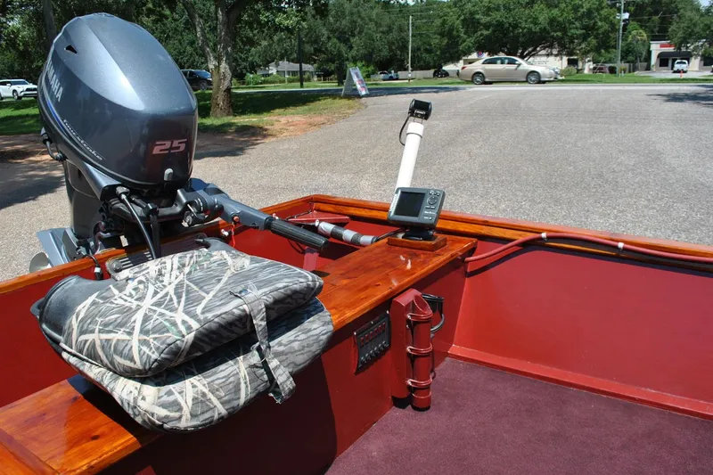 Slide: The Image of Custom 2014 Underwood boat with Yamaha 25 motor, camo seat, and navigation equipment. - 10