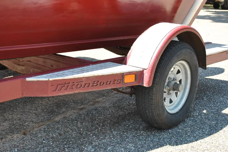 Slide: The Image of Red Triton Boats trailer with a single wheel, Custom Underwood model, 2014. - 22